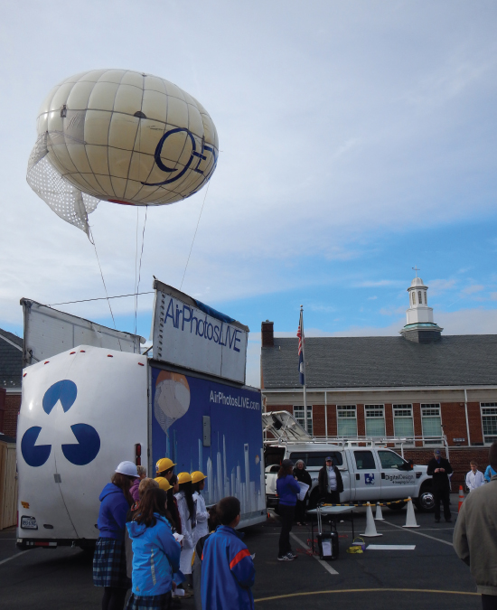 St. Thomas More students test their satellite by sending it 900 feet in the air in the school parking lot. (Courtesy of Melissa Pore)