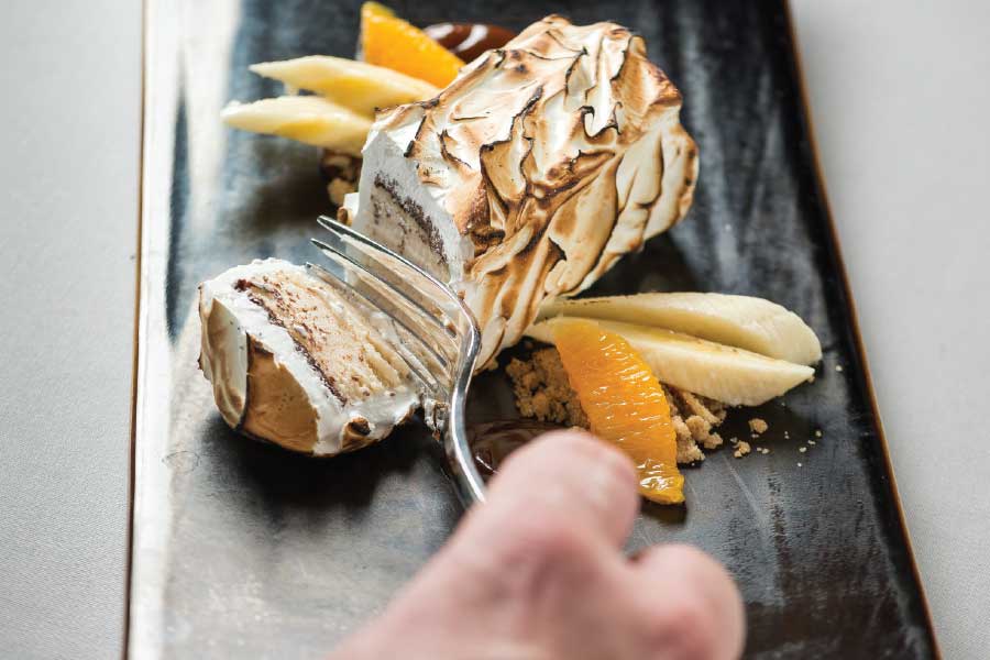 Baked alaska filled with peanut butter ice cream and torched for mere seconds at order. (Photo by Rey Lopez)